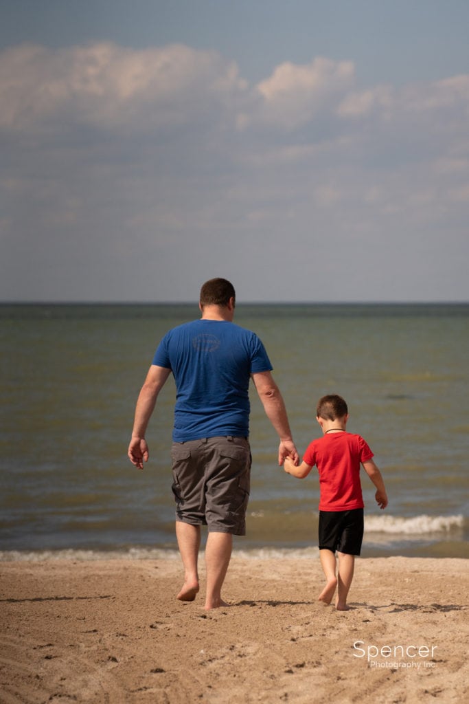 dad walking with son on Port Clinton Beach