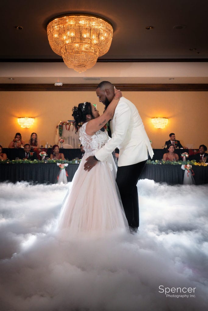 bride and groom dancing on the clouds