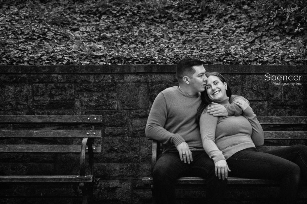 black and white engagement picture on bench