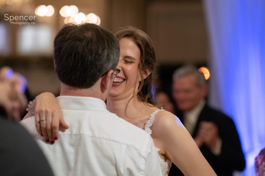 bride laughing at her wedding reception