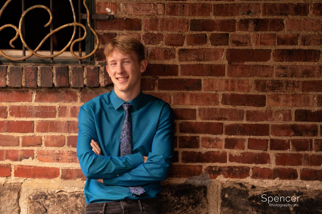 senior picture against brick wall in akron ohio