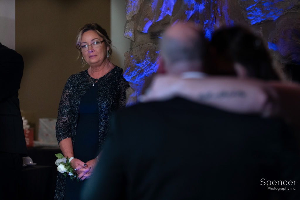 mother of bride watching father daughter dance