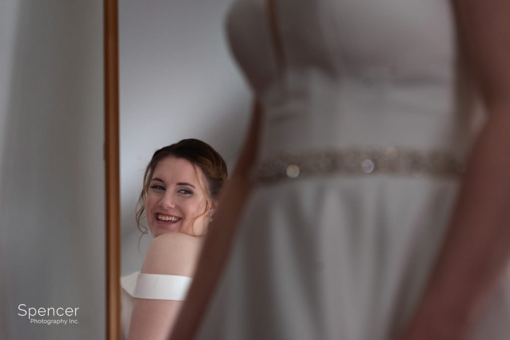 bride in mirror smiling