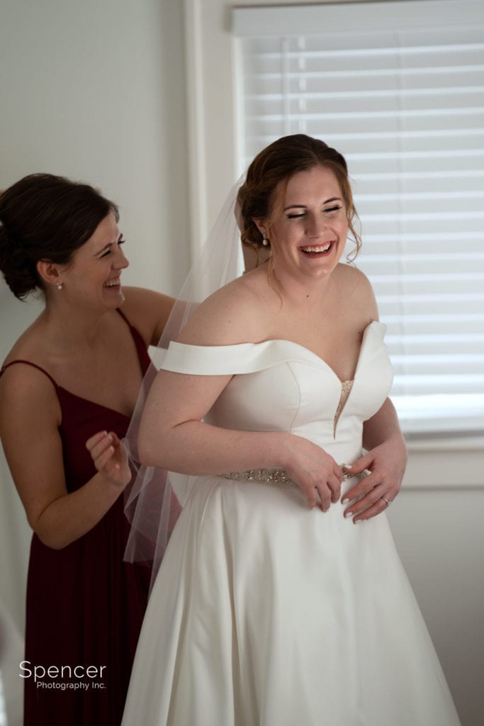bride laughing with maid of honor
