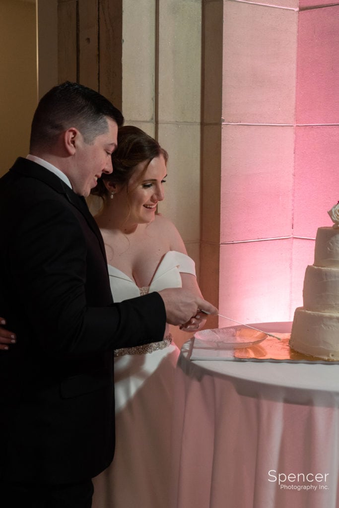 bride and groom cut wedding cake at Ariel Pearl Center