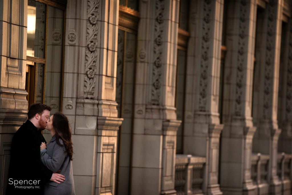 couple kissing in their engagement pictures near the Wrigley Building
