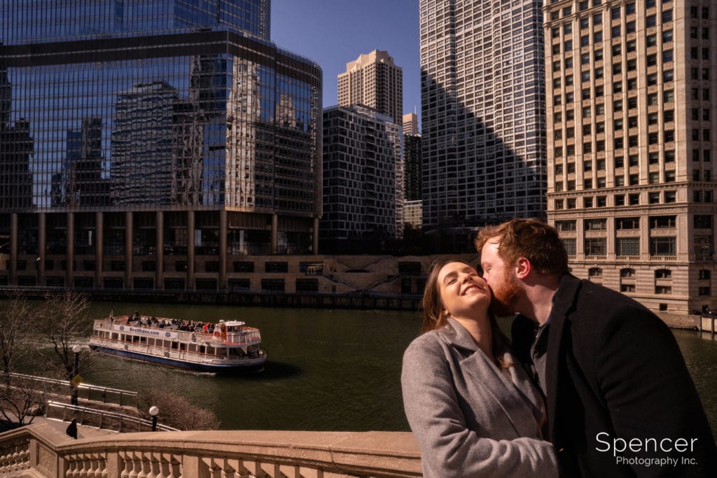 man kissing woman in Chicago engagement picture
