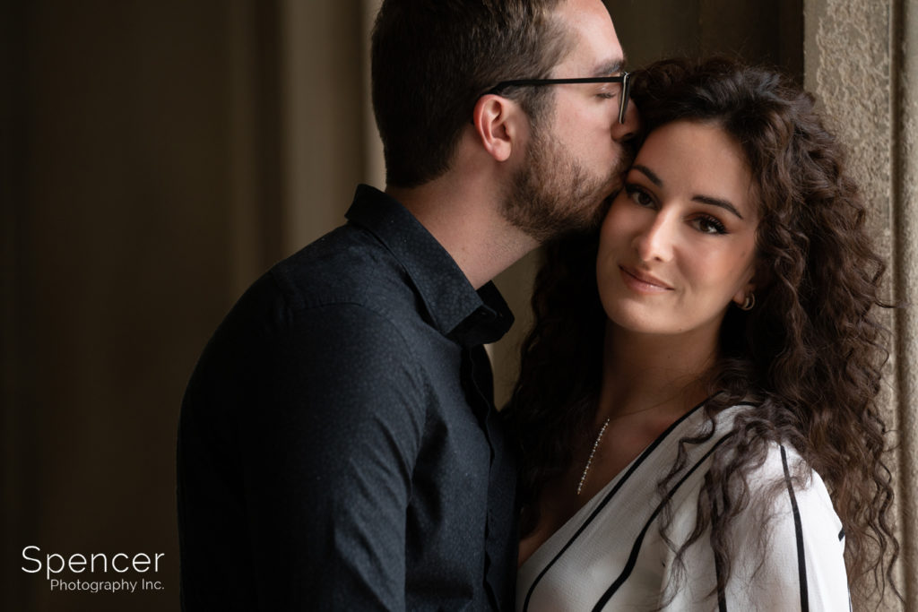 man kissing woman in engagment photo at Severance Hall