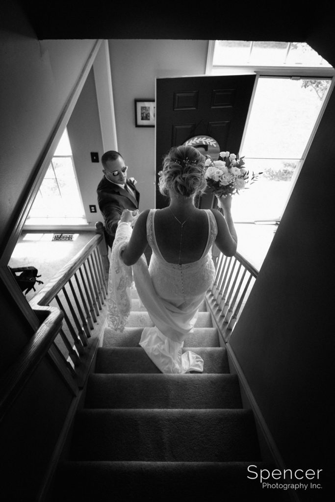 brides brother helping her down stairs
