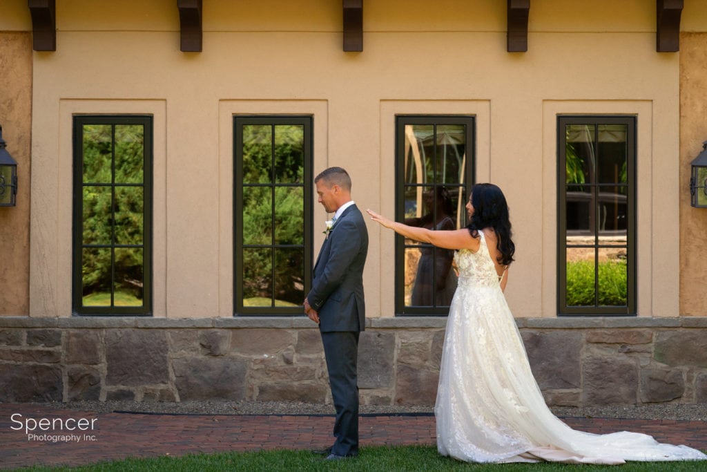 bride tapping groom for first look at Gervasi