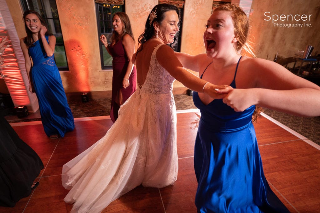 bride dancing with bridesmaid at wedding reception at Gervasi