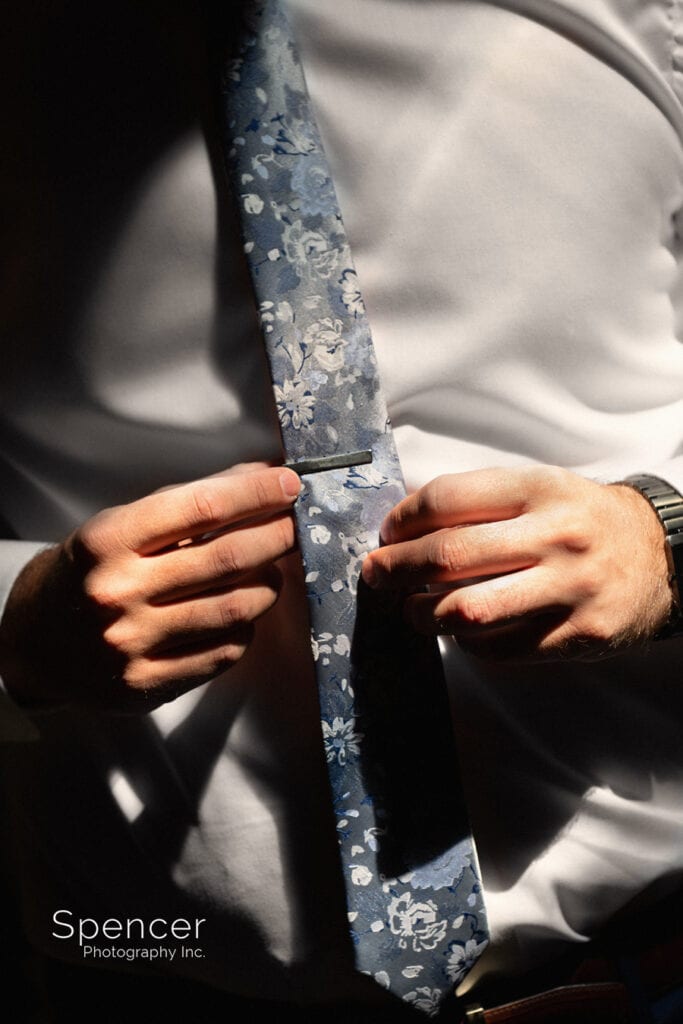 groom fixing tie