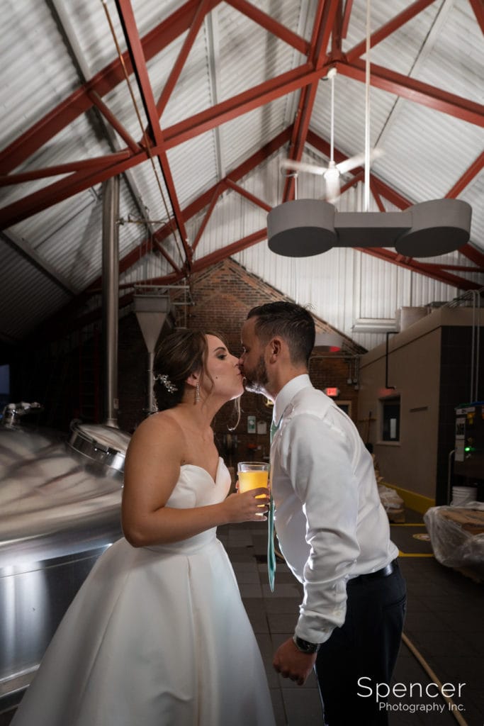  bride and groom kissing at wedding reception at Great Lakes Brewing