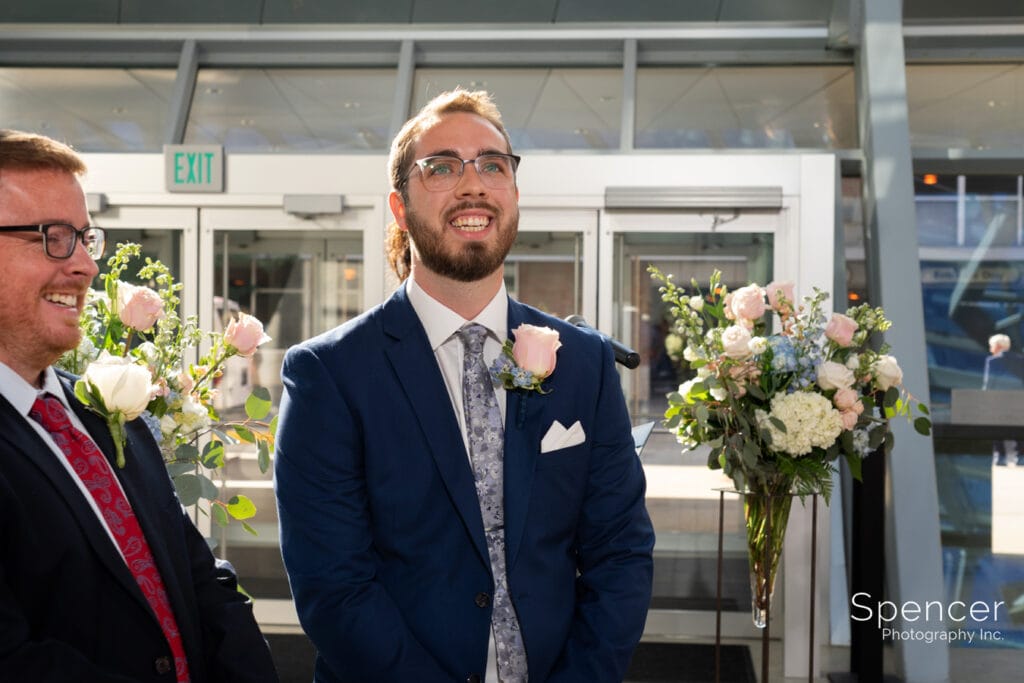 groom seeing bride for first time at Akron Art Museum wedding