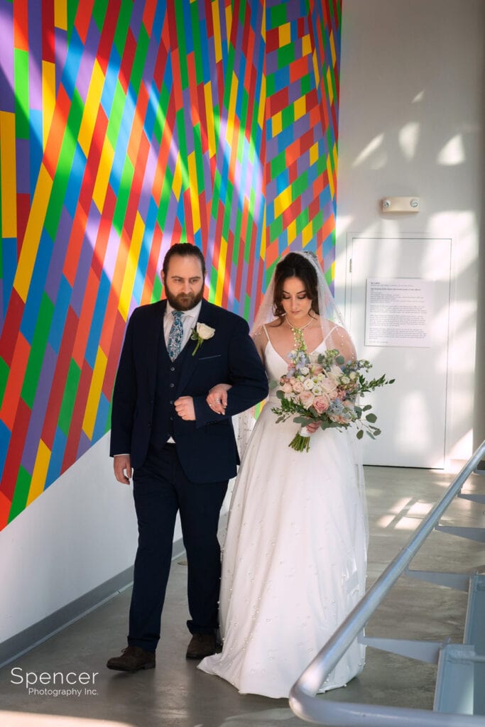 bride walking to wedding at Akron Art Museum