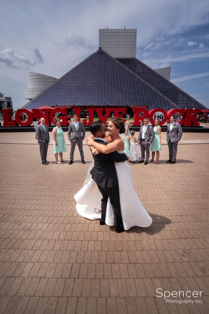 wedding party in front of Rock and Roll Hall of Fame