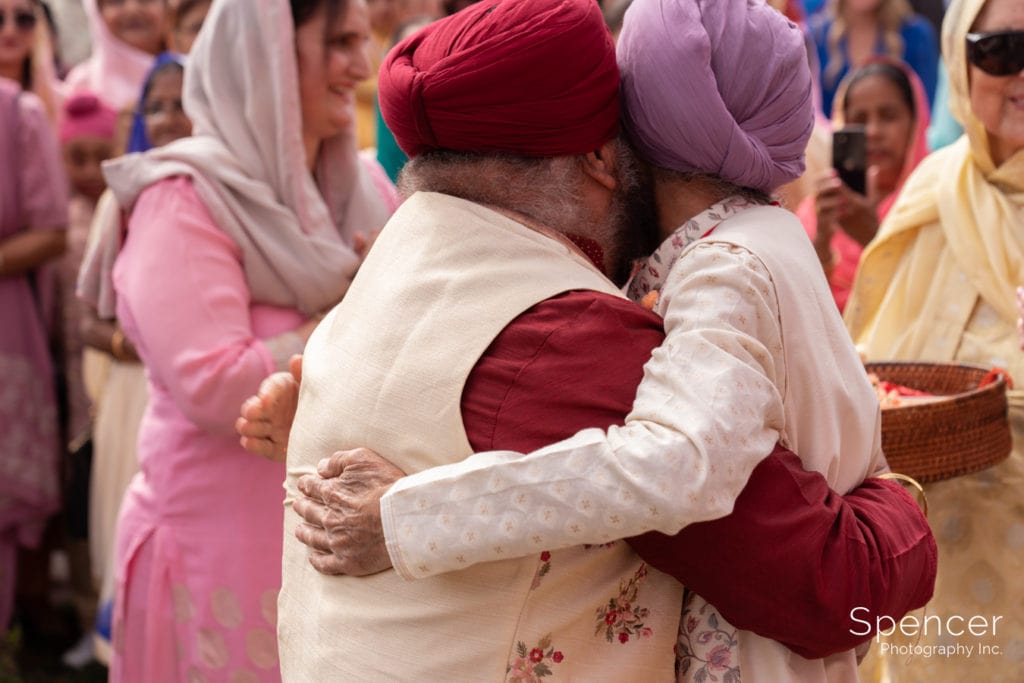 Sikh fathers embrace at Baraat