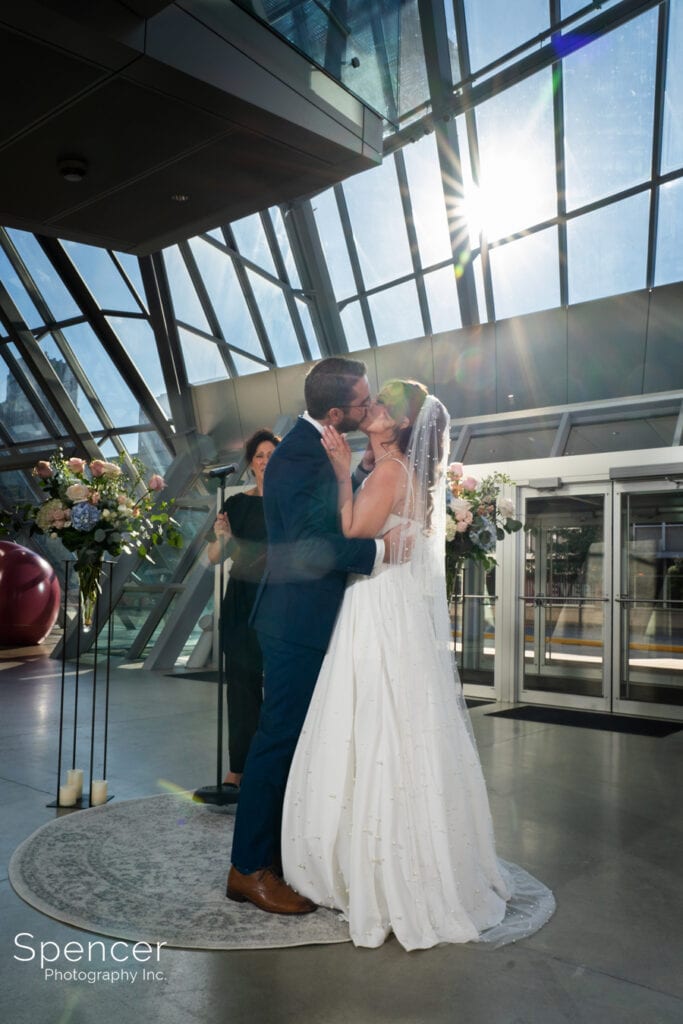 first kiss at wedding ceremony at Akron Art Museum