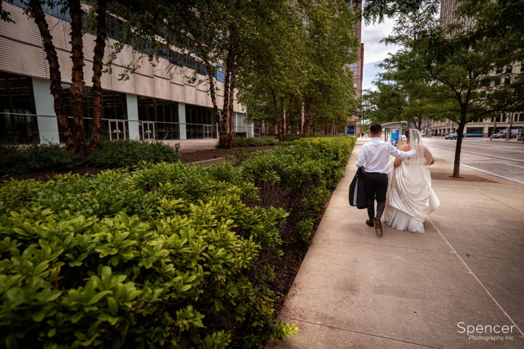 bride and groom walking in downtown Cleveland