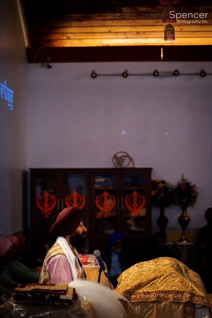 Sikh Granthi praying during wedding ceremony