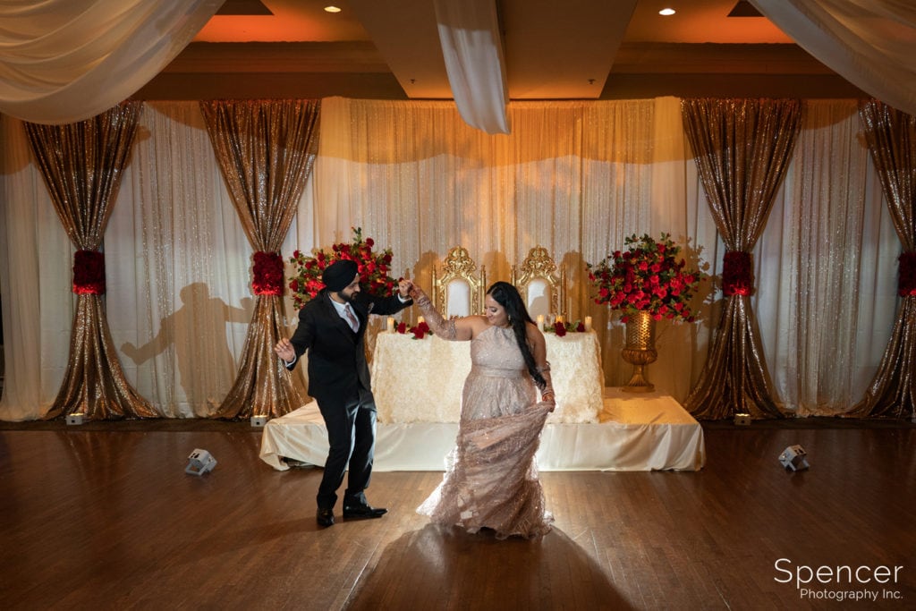 Sikh bride and groom enter wedding reception
