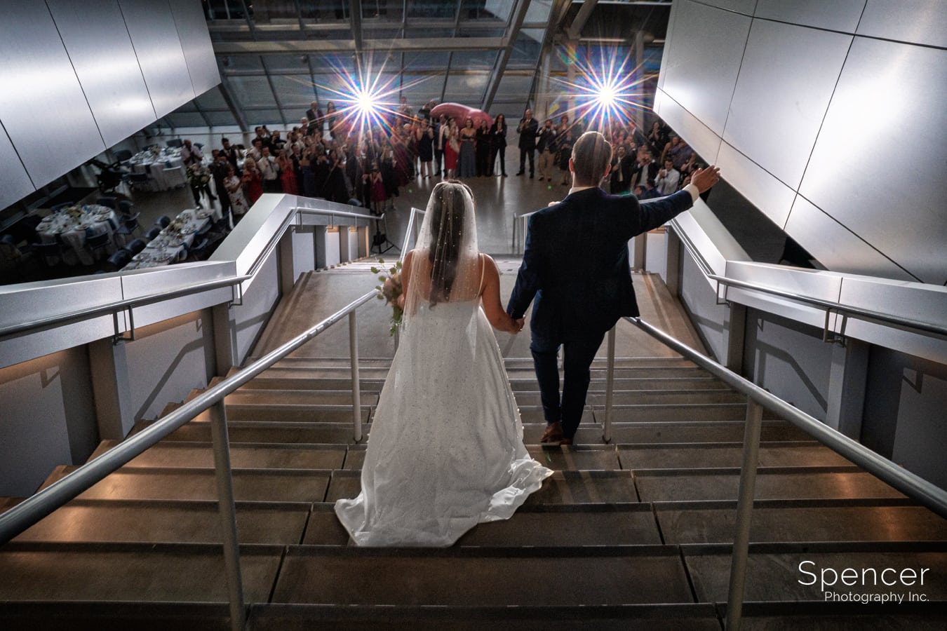 bride and groom entering their wedding reception at Akron Art Museum