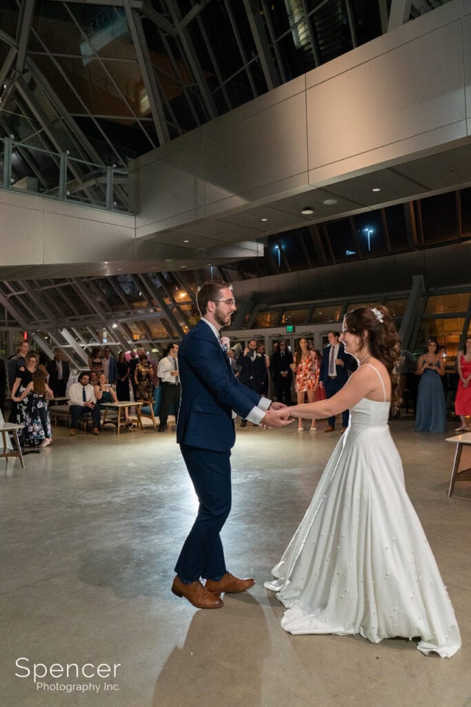 bride and groom finish first dance at Akron Art Museum