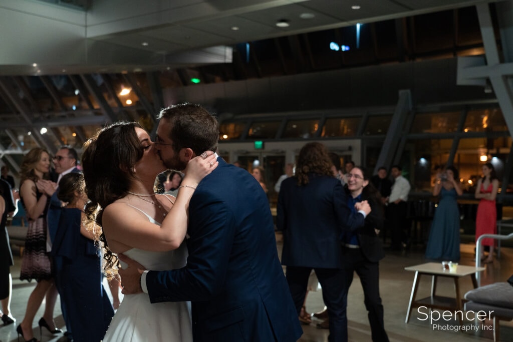 bride kissing groom at reception at Akron Art Museum