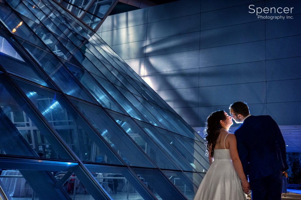 bride and groom kissing after wedding reception at Akron Art Museum
