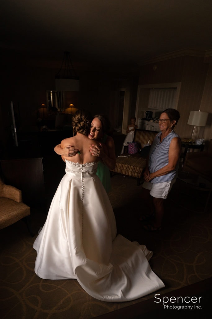  matron of honor hugging bride on wedding day at Cleveland Renaissance
