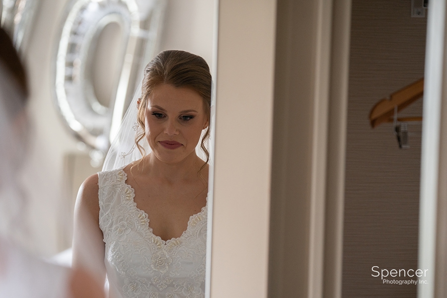  bride looking in mirror