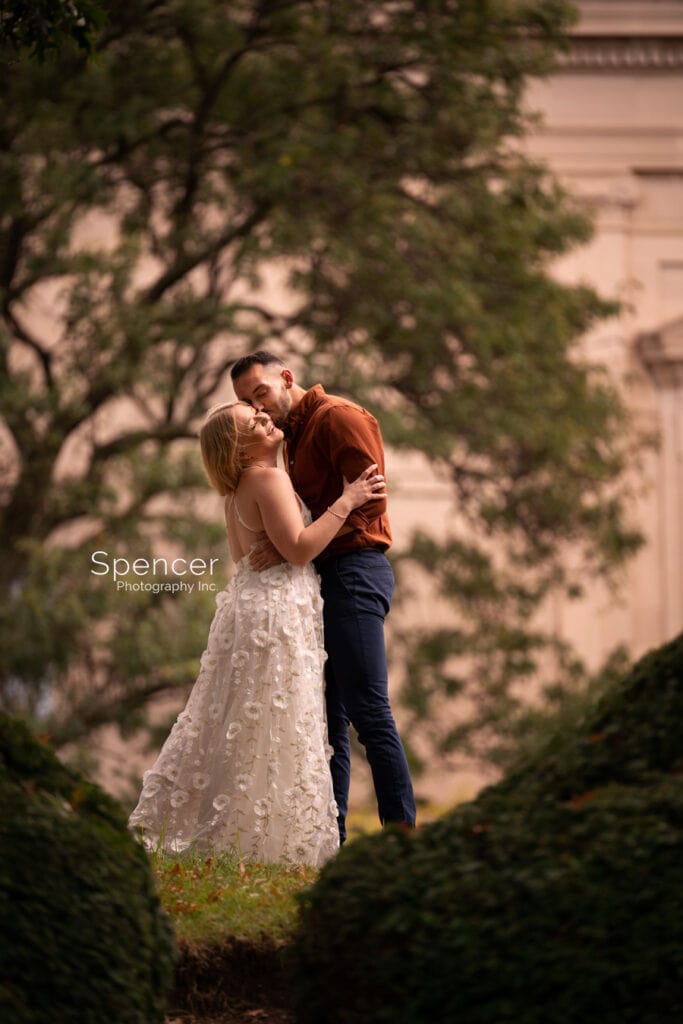 man kissing woman in engagement picture at Severance Hall