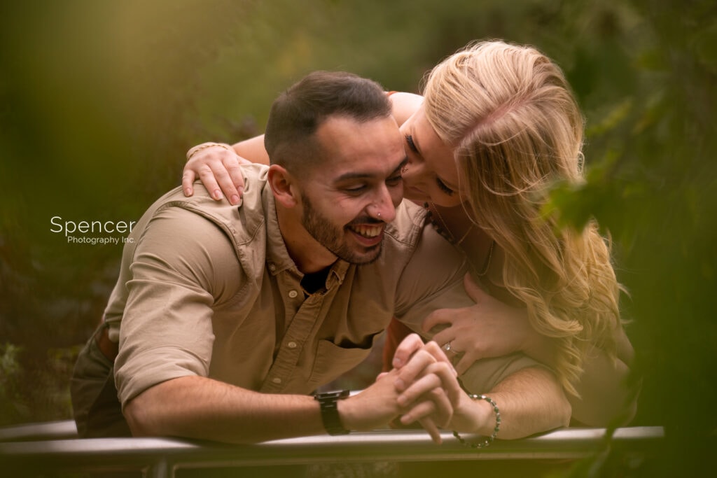 man smiling in engagement picture at Cleveland Botanical Garden