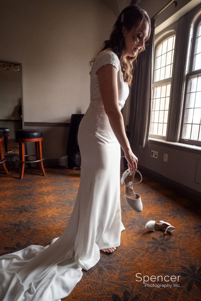bride putting on wedding shoes at Tudor Arms
