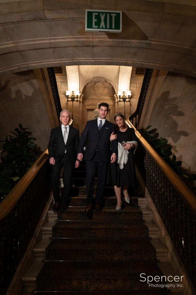 groom walking with parents to wedding ceremony at Marble Room