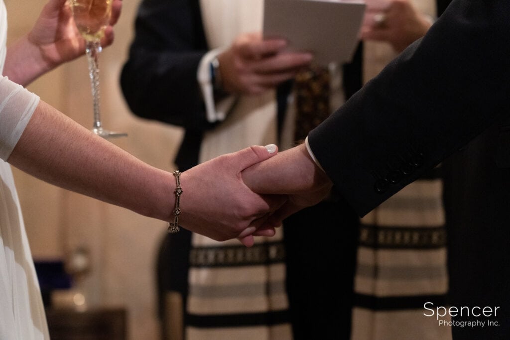  bride and groom holding hands during wedding at Marble Room