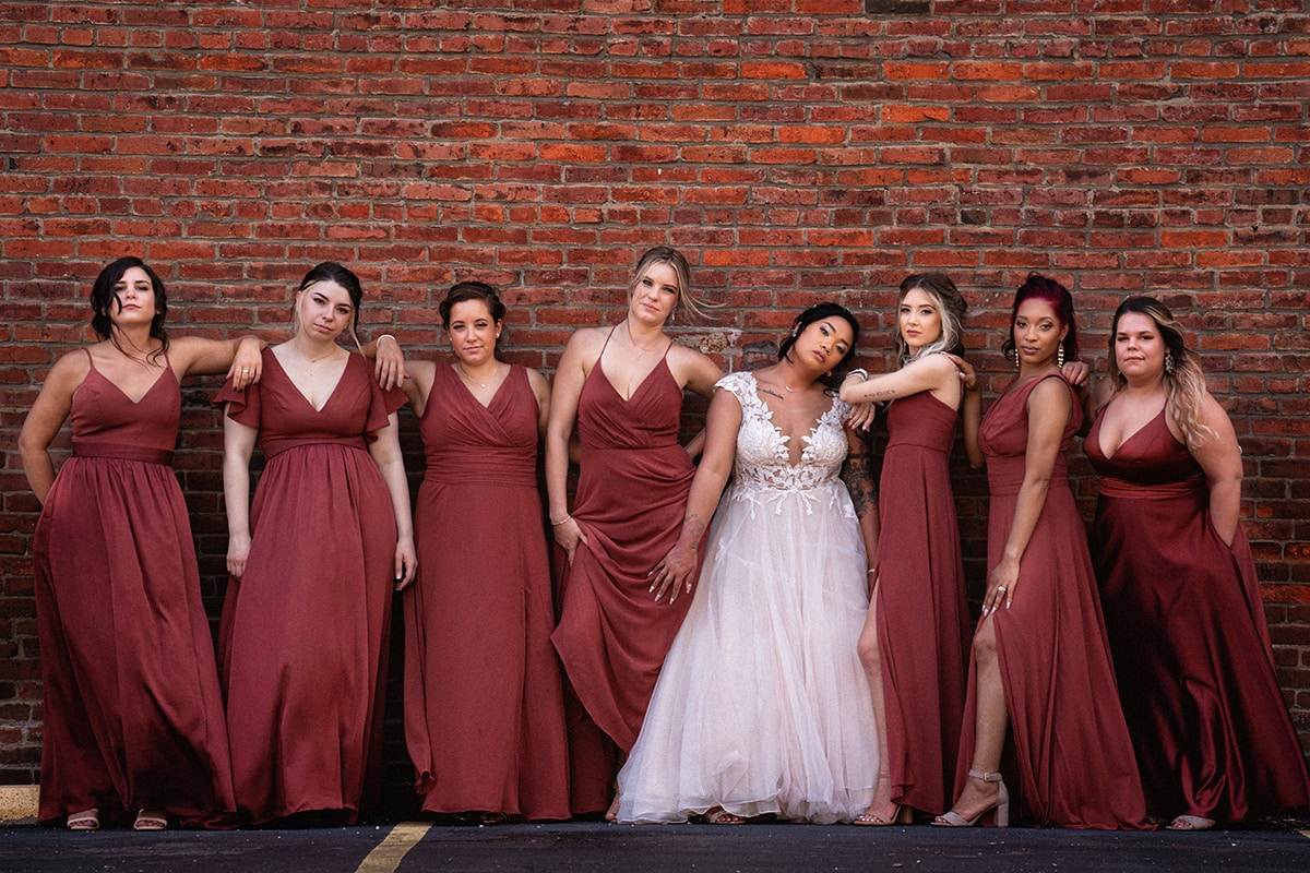 bridesmaids standing against brick wall in Cleveland