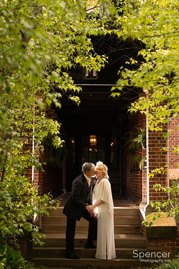bride and groom kiss at Stan Hywet