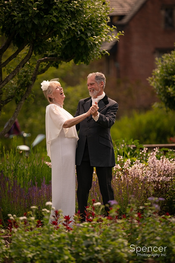 bride and groom dancing in gardens at Stan Hywet
