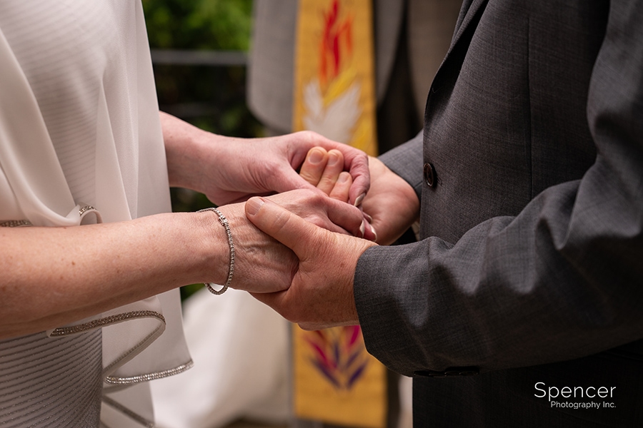 bride and groom holding hands at wedding ceremony O'Neil House