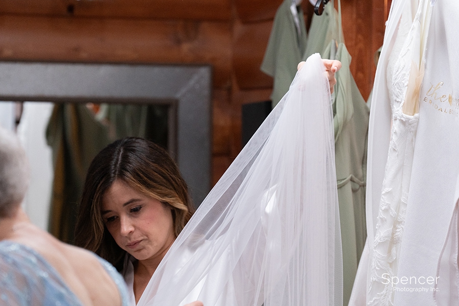 bride adjusting wedding veil at Parker Barn