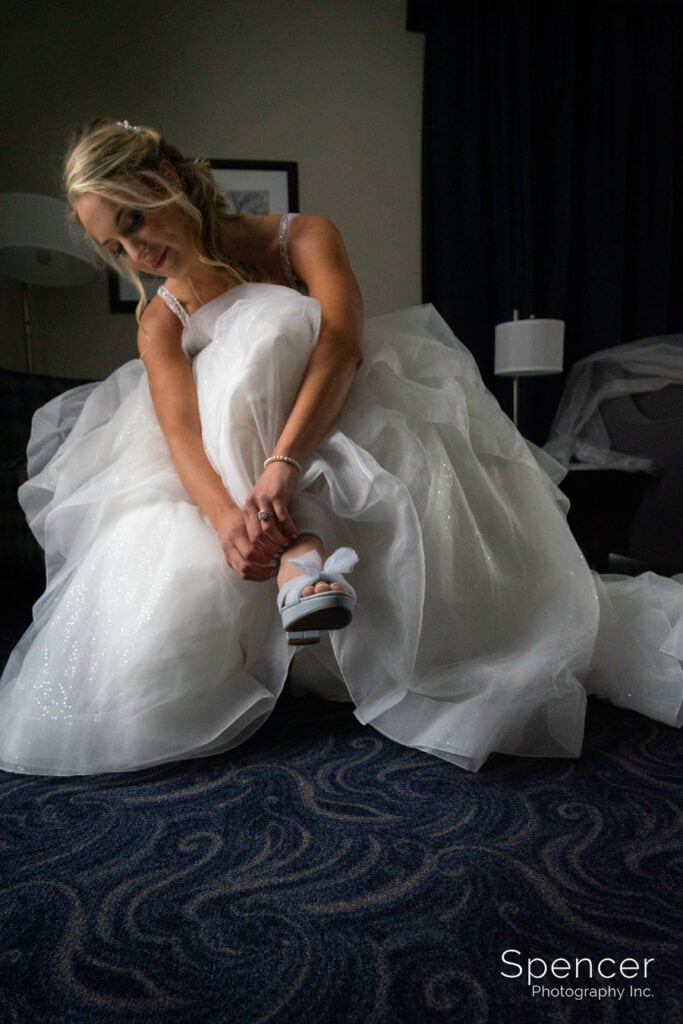 bride putting on wedding shoes in Kent Hotel