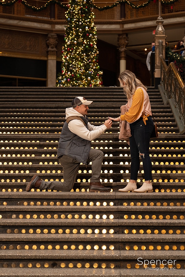man proposes to woman in Cleveland Arcade at Christmas