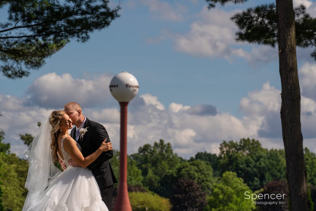 groom kissing bride at Firestone Country Club