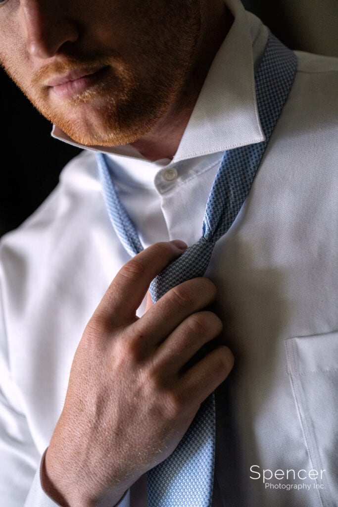 groom adjusting tie