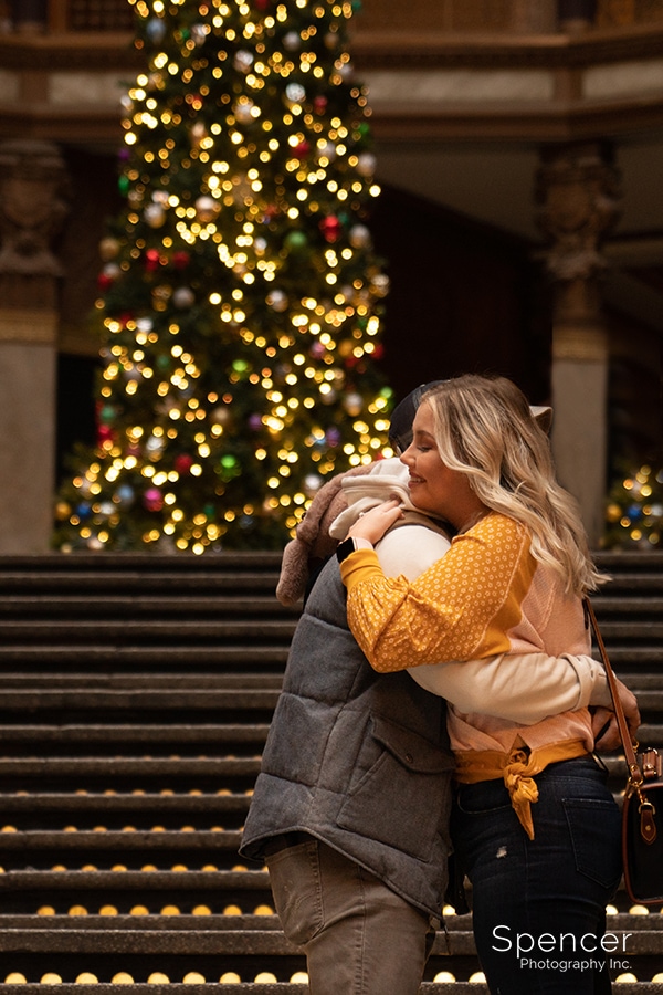 man proposes to woman in Cleveland Arcade at Christmas