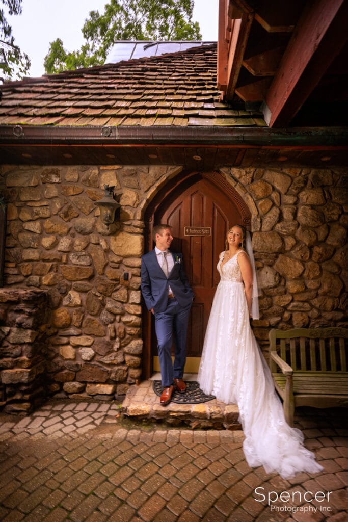 bride and groom standing in doorway at Landolls Mohican Castle