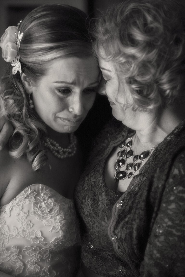 mom comforting crying bride