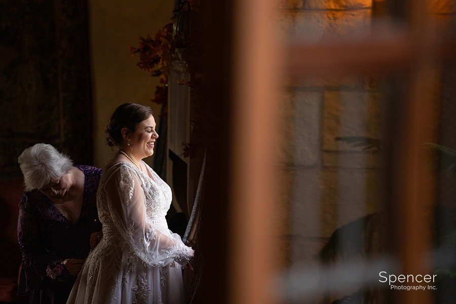 bride getting into wedding dress at Ewing Mansion
