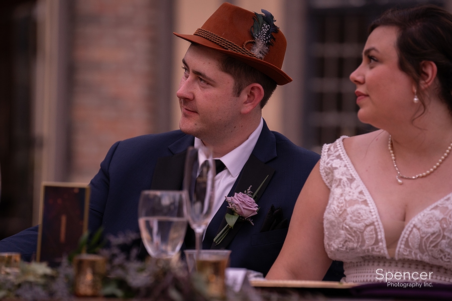 groom wearing hat at wedding reception at Ewing Manor